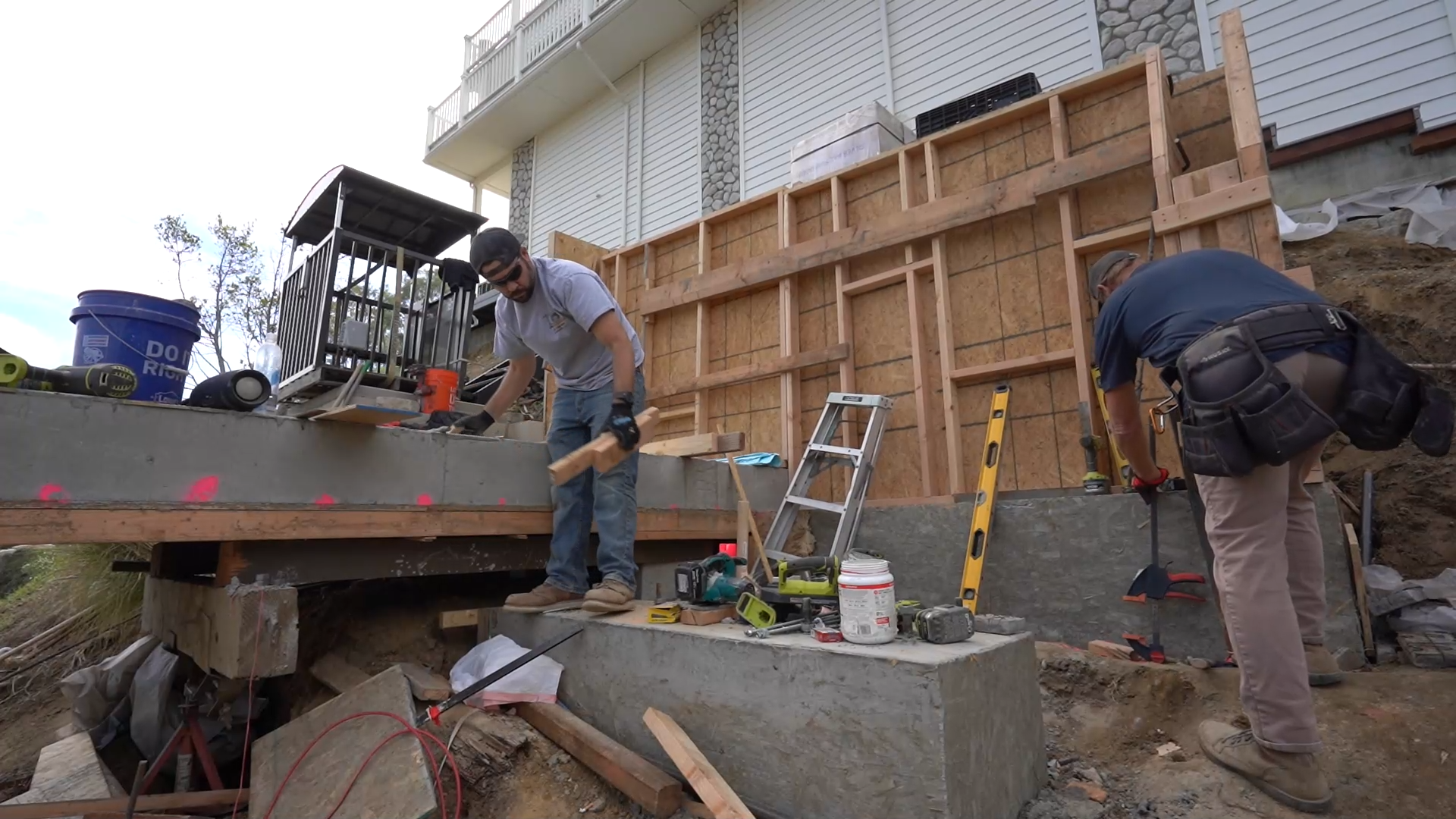 econstruct crew forming and pouring reinforced concrete base for the hillside lift at 50 Saddlebow Bell Canyon