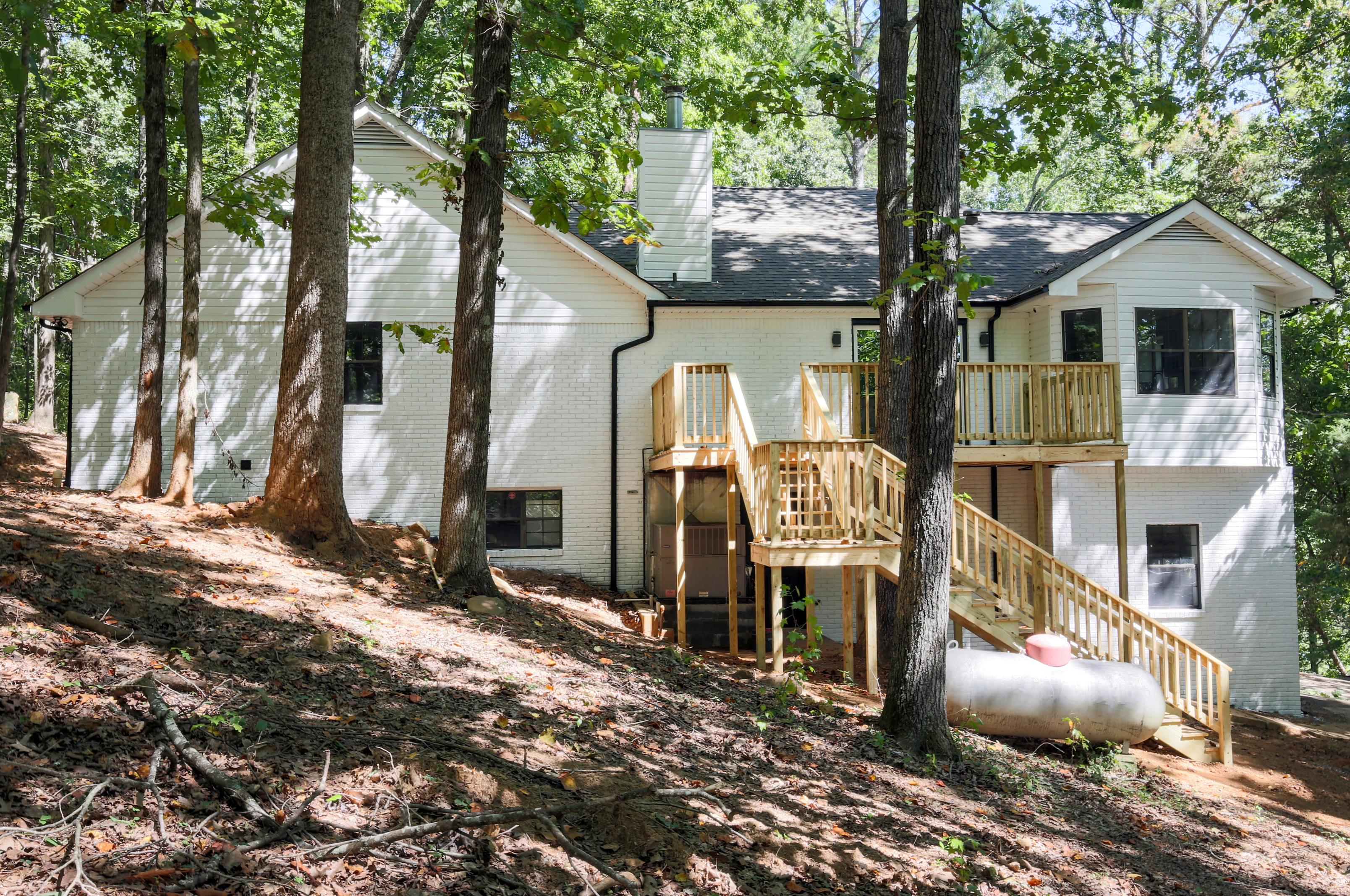 Newcomb Road hillside exterior view with natural landscaping