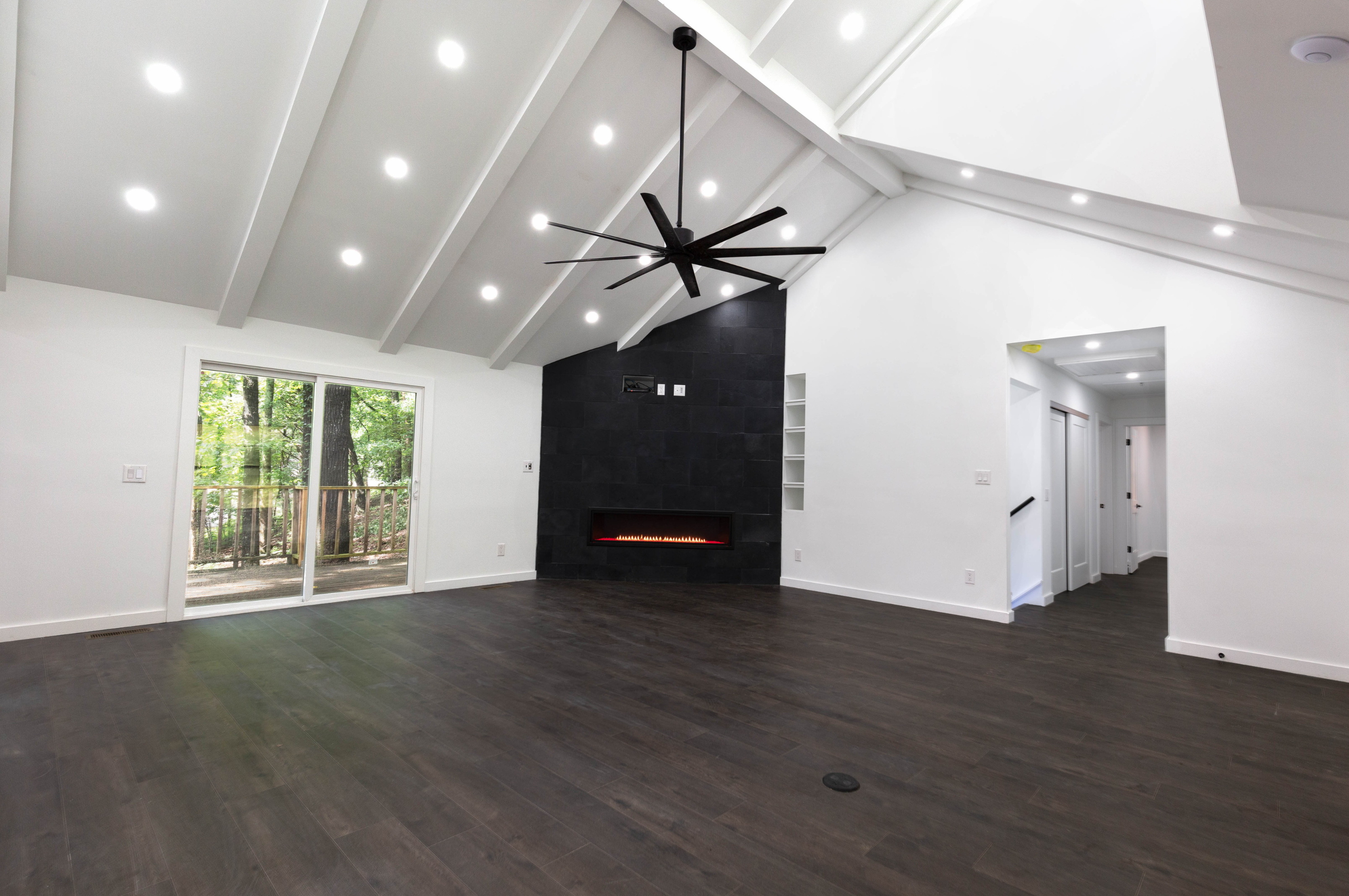 Newcomb Road living room with vaulted ceilings and hardwood floors